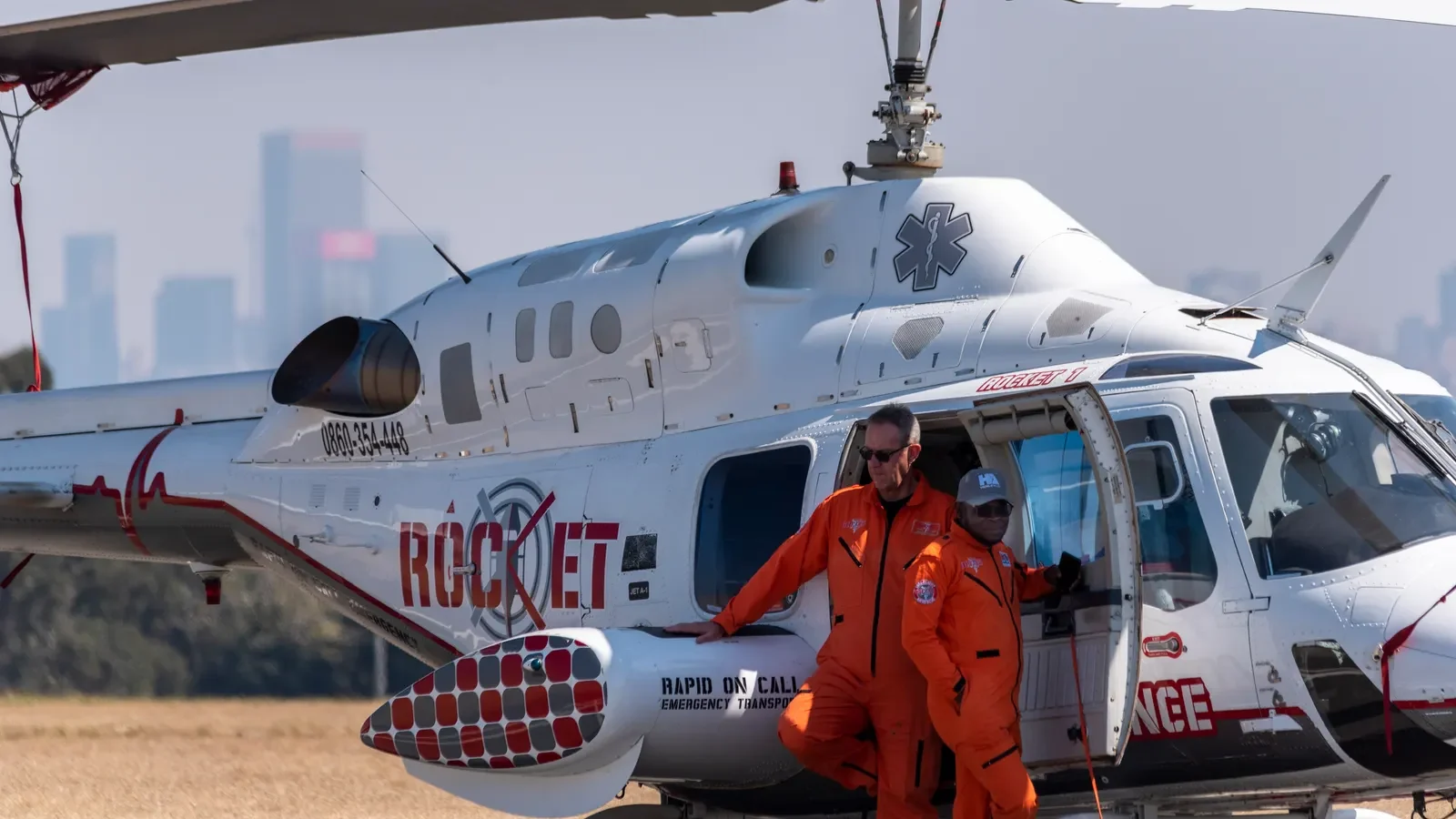 Ground medical team transferring a patient between ambulance and aircraft