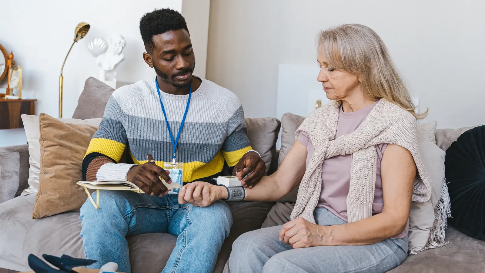 Healthcare professional providing coordinated care to a patient at home