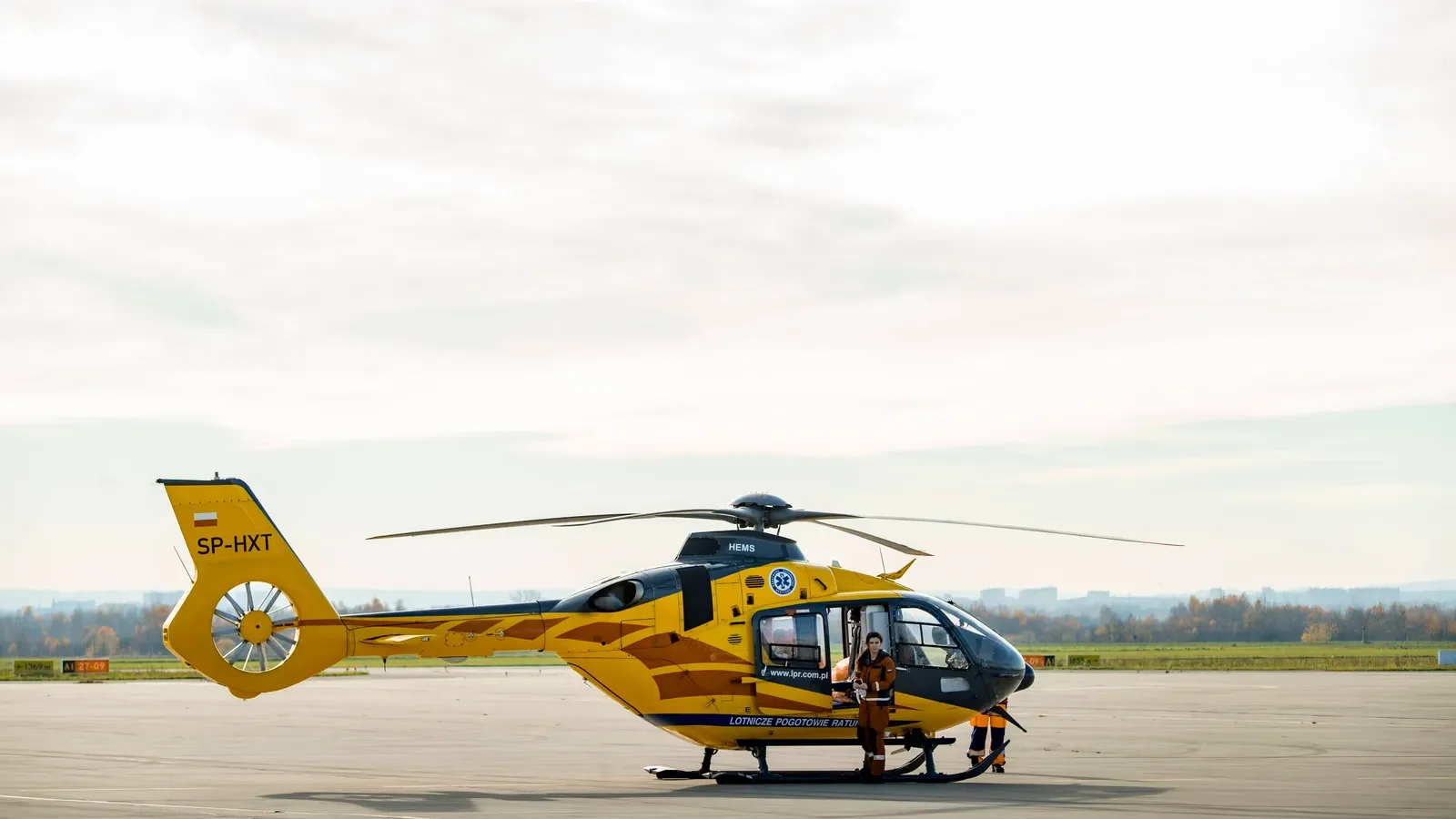 Medical transport team preparing a patient transfer beside an aircraft